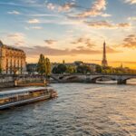 Seine sightseeing boat and Eiffel Tower at golden hour in Paris