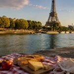 Affordable picnic with bread, cheese, and apples beside the Seine and Eiffel Tower