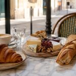 Croissant, baguette, French cheeses, pastry, and coffee at a Paris cafe